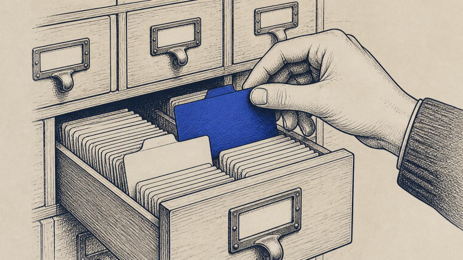 A hand reaching into a card catalogue, skipping a blank card and pulling a labelled one instead